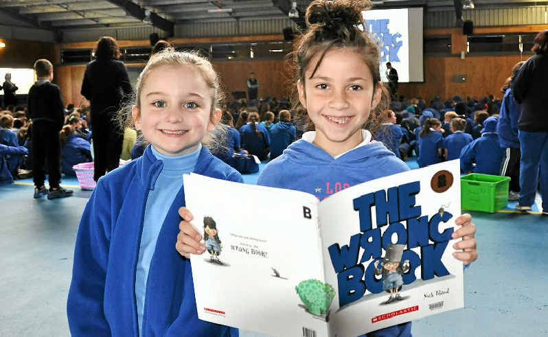 Year 1s Amity Willett and Gracie Forbes get familiar with The Wrong Book at Wednesday's Simultaneous Storytime. Year 1s Amity Willett and Gracie Forbes get familiar with The Wrong Book at Wednesday's Simultaneous Storytime.